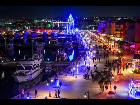  a night time view of the,boats,ships and cruises and restaurants of marina.